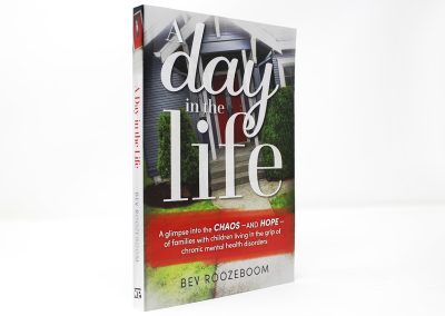 A Day In the Life book photo, showing the title in large white letters with a house with a red door in the background