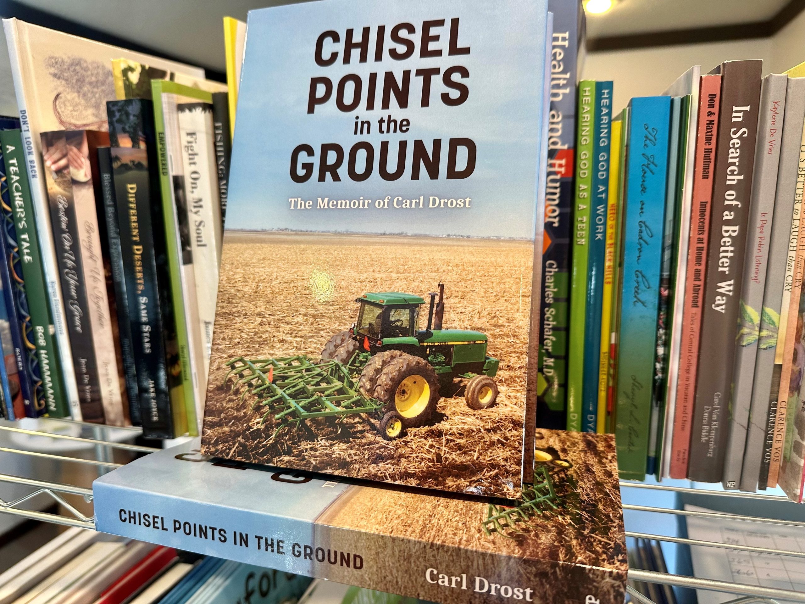 Two copies of Chisel Points in the Ground on a bookshelf