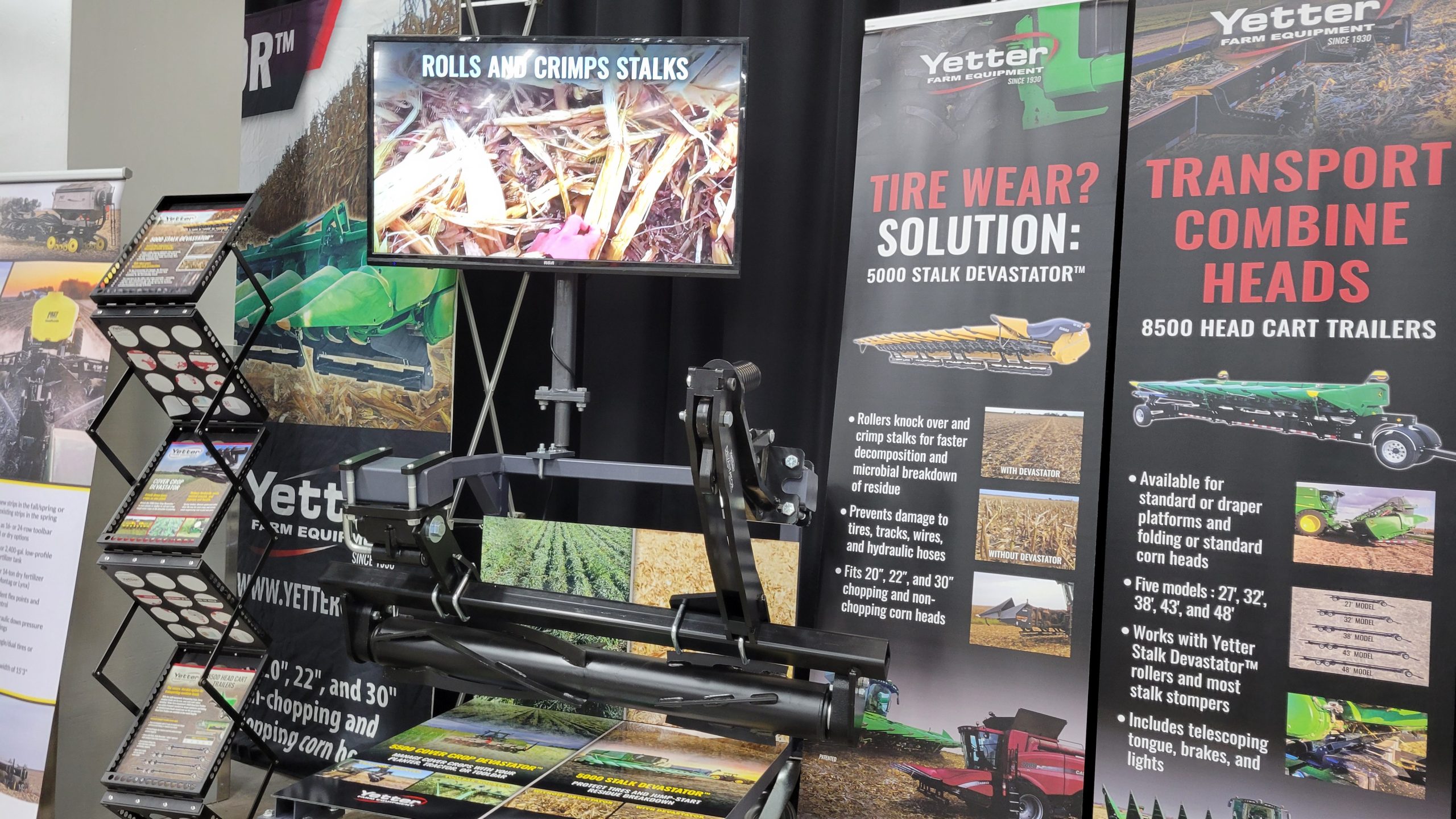 Yetter Stalk Devastator displayed alongside pull-up banners, flyers, and TV playing video