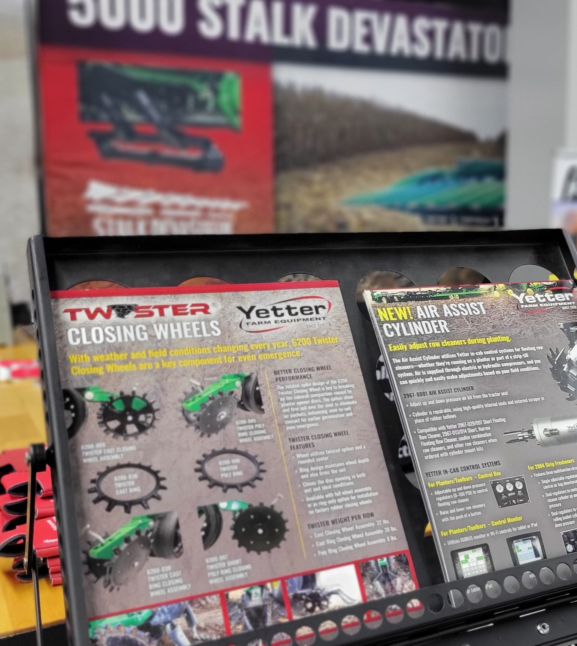 Yetter Twister Closing Wheel and Air Assist Cylinder flyers in holder in trade show booth