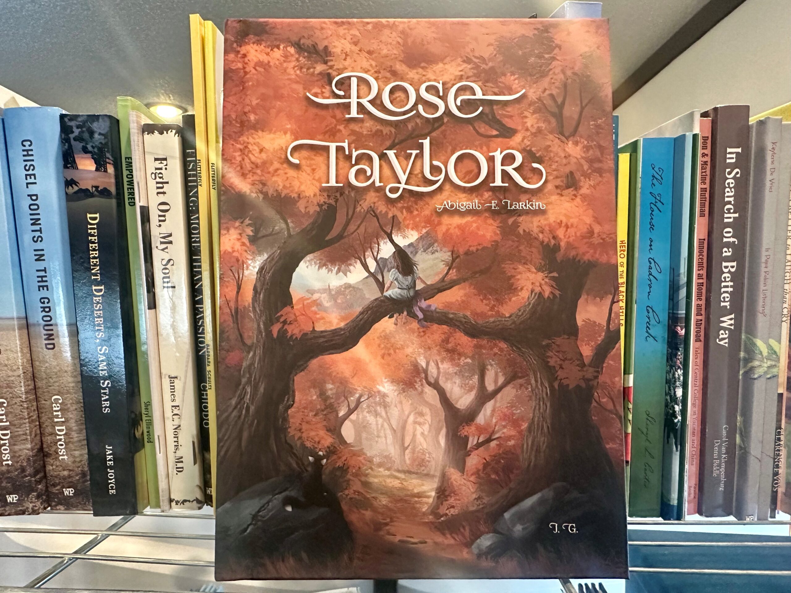 Copy of Rose Taylor sitting on Write Place bookshelf